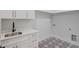 Convenient laundry room with sink and patterned floor at 2626 Sardis Way, Buford, GA 30519