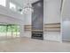 Open living area with a modern fireplace, built-in shelves, and large windows at 2626 Sardis Way, Buford, GA 30519