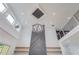 High ceiling living room with a large chandelier and a geometric fireplace feature wall at 2626 Sardis Way, Buford, GA 30519