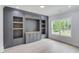 Media room with built-in entertainment center and large window at 2626 Sardis Way, Buford, GA 30519