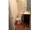 Simple bathroom with white toilet, dark wood vanity, and tiled floor at 2705 Greystone Pl, Austell, GA 30106