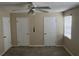 Bedroom featuring two closets, a ceiling fan, and neutral carpet at 2705 Greystone Pl, Austell, GA 30106