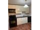 Compact kitchen with white cabinets, black appliances, and tile flooring at 2705 Greystone Pl, Austell, GA 30106