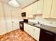 Efficient kitchen with white cabinets, black appliances, and tile floor at 2705 Greystone Pl, Austell, GA 30106