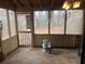 Enclosed sunroom with concrete floor and backyard views at 2705 Greystone Pl, Austell, GA 30106