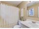 Clean bathroom with white fixtures, a shower/tub combo, and a window at 370 Charlyne Way, Dacula, GA 30019