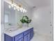 Modern bathroom with blue vanity, gold fixtures, and large mirror at 370 Charlyne Way, Dacula, GA 30019