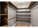 Walk-in closet with wooden shelves and hanging rods at 370 Charlyne Way, Dacula, GA 30019