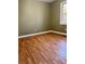 Simple bedroom with light green walls and wood flooring at 4212 Anneewakee Rd, Douglasville, GA 30135