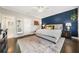 Main bedroom with a navy accent wall and large bed at 7008 Senaca Ct, Roswell, GA 30076