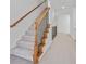 Carpeted staircase with decorative metal railing and hardwood treads at 2260 Edgartown Se Ln # 1, Smyrna, GA 30080