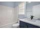 Modern bathroom with blue vanity and white tub at 2612 Grove Park Ln, Conyers, GA 30094