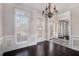 Formal dining room with hardwood floors, chandelier and wainscoting at 2612 Grove Park Ln, Conyers, GA 30094