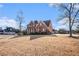 Brick house with a side view showcasing the garage and landscaping at 2612 Grove Park Ln, Conyers, GA 30094