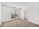 Bright bedroom with grey carpet and large window at 966 Moda Dr, Atlanta, GA 30316