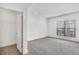 Spacious bedroom with grey carpet and a large window at 966 Moda Dr, Atlanta, GA 30316