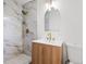 Bathroom with marble shower, wood vanity, and gold fixtures at 2686 Abilene Trl, Snellville, GA 30078