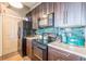 Modern kitchen with dark wood cabinets and green tile backsplash at 32 Peachtree Nw St # 1106, Atlanta, GA 30303