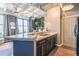 Modern kitchen with dark wood cabinets and a breakfast bar at 32 Peachtree Nw St # 1106, Atlanta, GA 30303