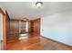 Living room with hardwood floors, wood paneling, and a door and window at 784 Sylvan Dr, Marietta, GA 30066