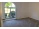 Bright bedroom with arched window and grey carpet at 7092 Shore Rd, Lithonia, GA 30058