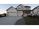 Two-story house with three car garage and landscaped front yard at 227 Wild Ginger Bnd, Woodstock, GA 30188