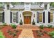 Stunning brick home with double front doors, shutters, and manicured landscaping at 4404 Paces Battle Nw, Atlanta, GA 30327