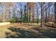 Large backyard with fenced perimeter and mature trees at 175 Jayne Ellen Way, Alpharetta, GA 30009