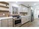 Modern kitchen with white cabinets, brick backsplash, and stainless steel appliances at 175 Jayne Ellen Way, Alpharetta, GA 30009