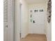 Welcoming entryway with white door, light wood floors, and closet with louvered doors at 605 Patrick Ne Pl, Sandy Springs, GA 30328