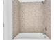 Bathroom with a bathtub and taupe mosaic tile at 775 Juniper Ne St # 619, Atlanta, GA 30308
