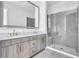 Modern bathroom with double vanity, large mirror, and a glass shower at 775 Juniper Ne St # 619, Atlanta, GA 30308