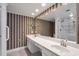 Bathroom with double vanity, large mirror, and patterned wallpaper at 6851 Roswell Rd # D14, Atlanta, GA 30328
