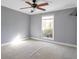 Bedroom with gray walls, a ceiling fan, and large window with natural light at 6851 Roswell Rd # D14, Atlanta, GA 30328