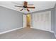 Spacious bedroom with ceiling fan, closet, and plush carpet at 6851 Roswell Rd # D14, Atlanta, GA 30328
