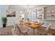 Virtually staged dining room with wood table, built-in shelving, and chandelier at 6851 Roswell Rd # D14, Atlanta, GA 30328