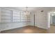 Dining room with extensive built-in shelving, chandelier, and wood-look floors at 6851 Roswell Rd # D14, Atlanta, GA 30328