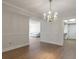 Dining room with chandelier, wood floors, and views into adjacent rooms at 6851 Roswell Rd # D14, Atlanta, GA 30328