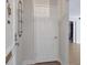 Simple entryway with a white door, wall-mounted shelving, and wood-look flooring at 6851 Roswell Rd # D14, Atlanta, GA 30328