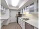 Bright kitchen with white cabinets, stainless steel appliances, and wood-look flooring at 6851 Roswell Rd # D14, Atlanta, GA 30328