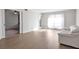 Spacious living room with wood floors and access to another room through double doors at 6851 Roswell Rd # D14, Atlanta, GA 30328