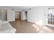 Open-concept living and dining area with wood flooring and neutral paint at 6851 Roswell Rd # D14, Atlanta, GA 30328