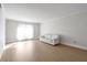 Bright living room with wood floors, white walls, and a white sofa at 6851 Roswell Rd # D14, Atlanta, GA 30328