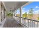 Large porch with white columns overlooking wooded area at 1222 Wisteria Bluff Ct, Hoschton, GA 30548