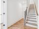 Stairway with wooden steps and black metal railing in a white hallway at 1561 Layton Lane Nw Dr # 21, Atlanta, GA 30318