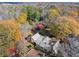 Aerial shot of the home, backyard, and surrounding trees with fall foliage at 7865 Nesbit Ferry Rd, Sandy Springs, GA 30350