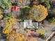 Birds-eye view of the property with fall foliage and outbuildings at 7865 Nesbit Ferry Rd, Sandy Springs, GA 30350