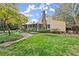 Charming home with screened porch, lush lawn, and mature trees at 7865 Nesbit Ferry Rd, Sandy Springs, GA 30350
