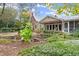 Backyard view of the home, pond, and landscaping at 7865 Nesbit Ferry Rd, Sandy Springs, GA 30350