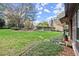 Expansive backyard with a stone walkway, lush lawn, and mature foliage at 7865 Nesbit Ferry Rd, Sandy Springs, GA 30350